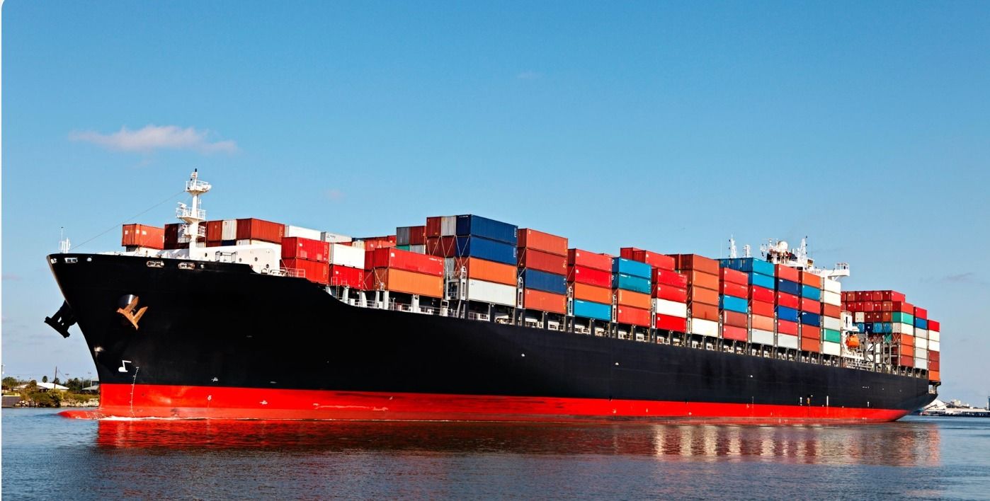 Container ship at sea loaded with stacked containers